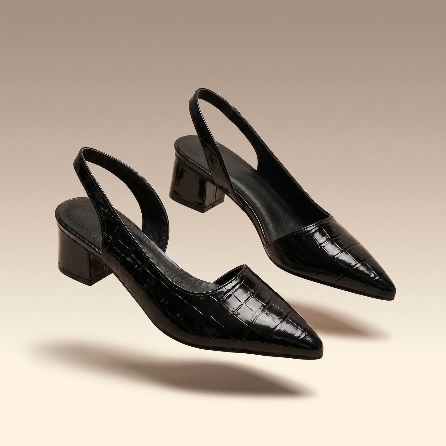 Solène black croc-embossed pointed-toe slingback block heel pumps on ivory background