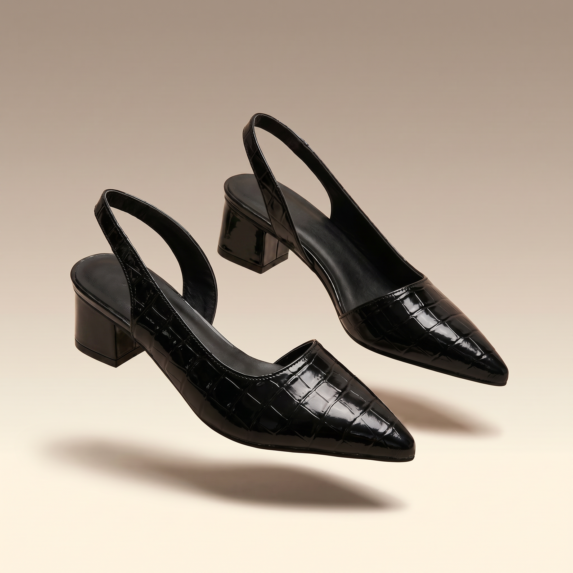 Solène black croc-embossed pointed-toe slingback block heel pumps on ivory background