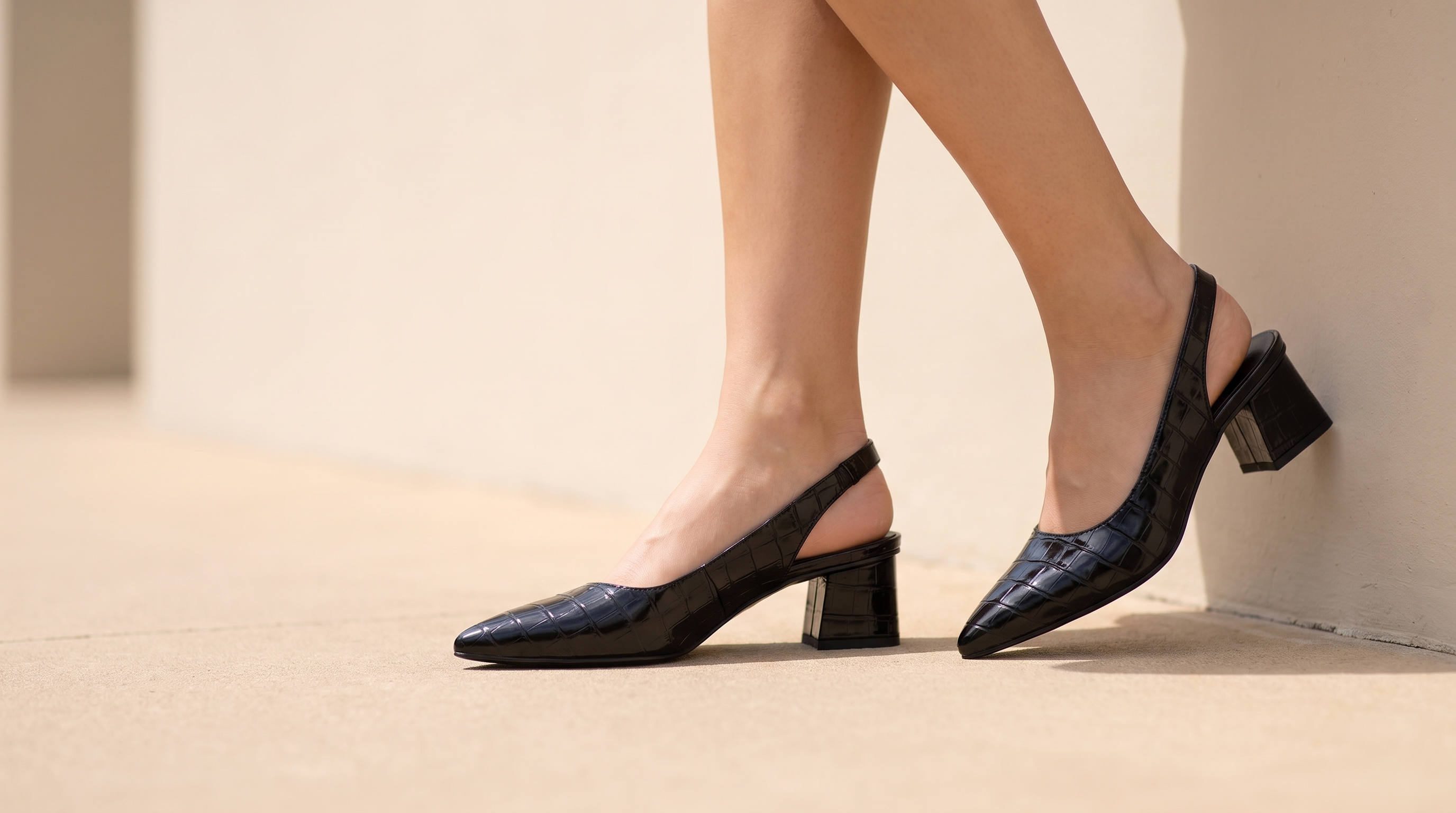 Woman wearing Solène black pointed-toe slingback block heels on a Paris street