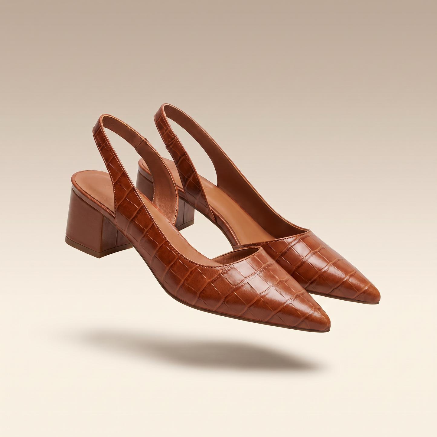 Solène brown croc-embossed pointed-toe slingback block heel pumps on taupe background