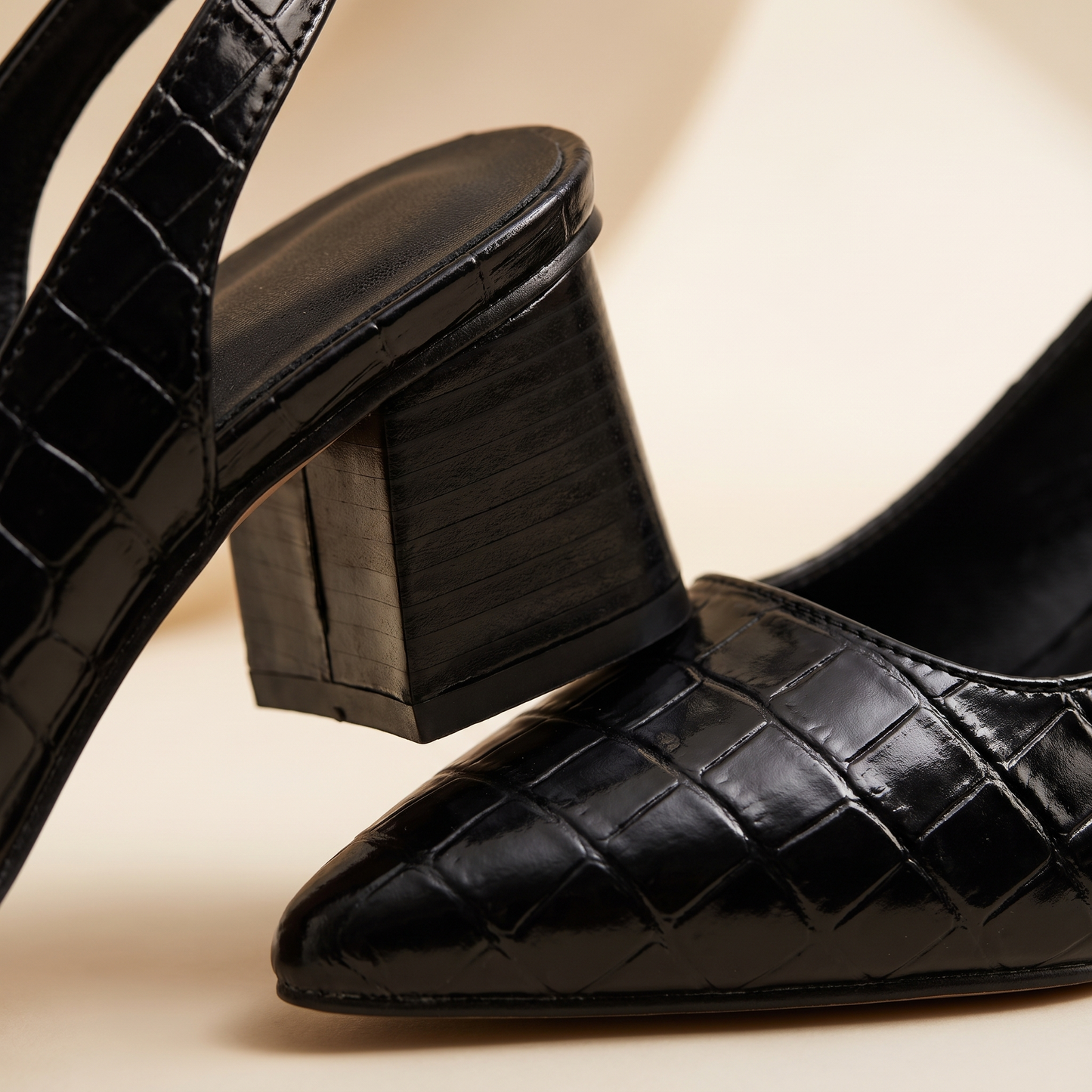 Close-up of the croc-embossed texture and block heel of Solène slingback heels